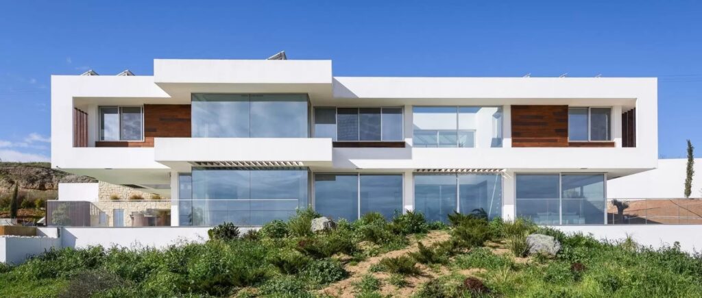 B1 luxury modern villa house design in europe with floor to ceiling glazing sliding glass doors and glass balustrades