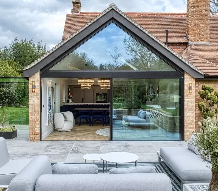 Sieger slim sliding glass doors and large gable end windows used to create a glass wall in this modern home renovation