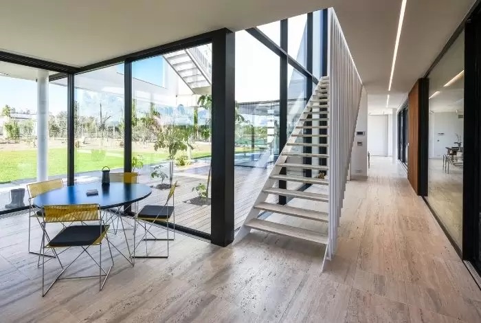 interior of a luxury modern holiday villa with multiple sliding doors and oversized glazing.jpg