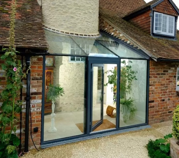 schuco aluminium casement door with fixed sidelights and an invio structural glass roof.jpg